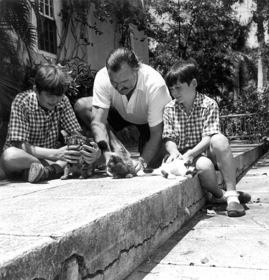 Hemingway with sons Patrick and Gregory with kittens