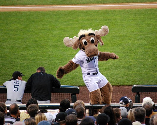 Moose mascot dancing in front of the crowd at a baseball game